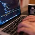 A person coding on a laptop