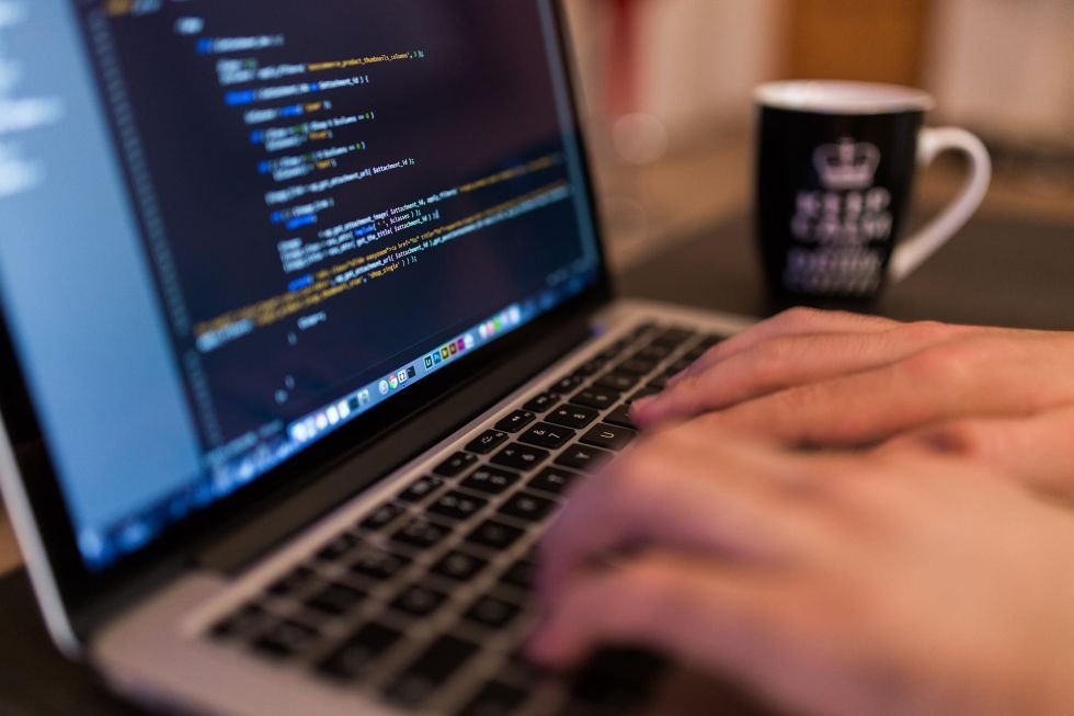A person coding on a laptop